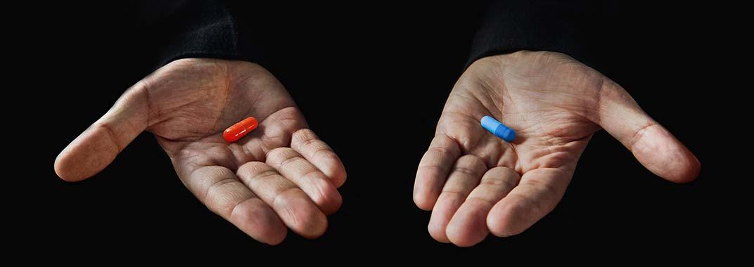 Tech education revolution Hands with red and blue pill
