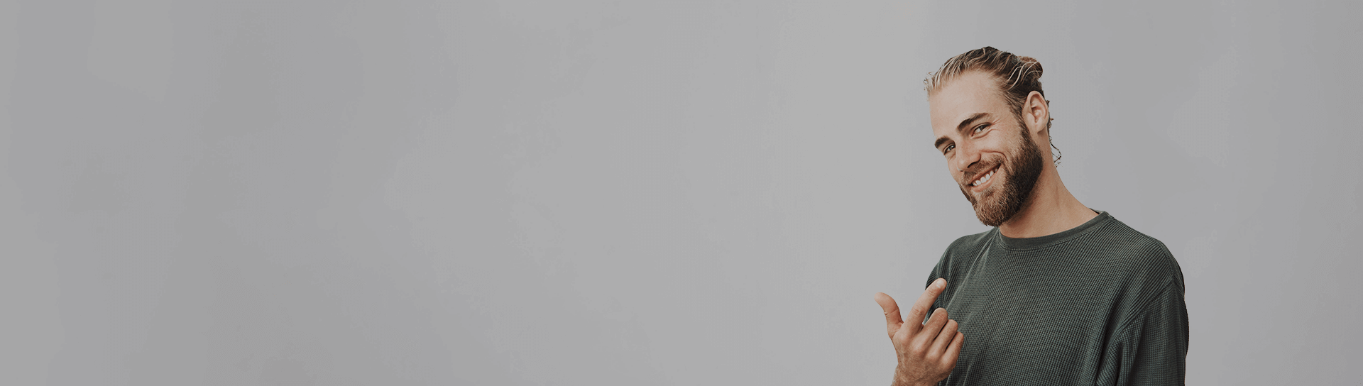 Young smiling man with beard image Young smiling man with beard on grey background