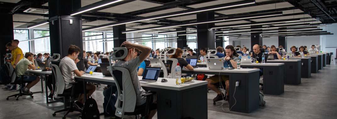 Coding bootcamp in times of recession Open office with programmers