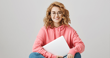 Smiling woman with glasses and laptop